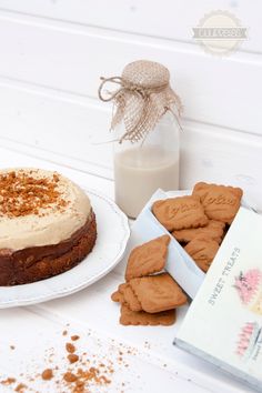 there is a cake and cookies on the table next to a bottle of milk with a card in front of it