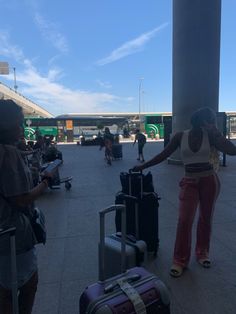 a woman standing next to luggage at an airport