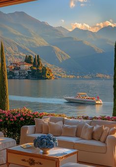 a living room filled with furniture next to a lake