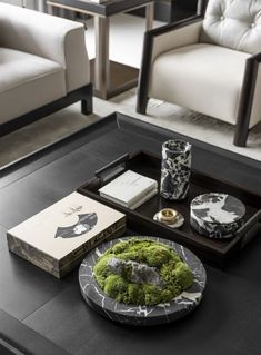 a black table topped with a tray filled with books