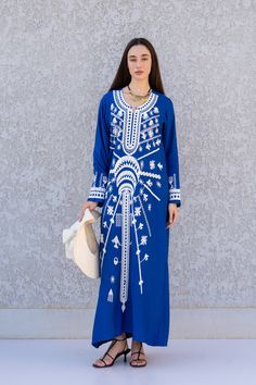 "**Note : The kaftan in the video is a different color of the exact same Kaftan and is only displayed to show the fit, flow, and cut of the Kaftan. You will receive the one in the pictures.** This beautiful Kaftan with the Siwa inspired embroidery is a bohemian and flashy dress that will catch everyone's eyes. it is a show stopper. This Kaftan is ideal to wear for any casual occasion. Whether taking a trip down the shopping lane, or home-based kitty parties, or about anything else, wearing this Traditional Blue Maxi Dress For Eid, Blue Floral Embroidered V-neck Kaftan, Blue V-neck Kaftan With Floral Embroidery, Traditional Blue V-neck Kaftan, Blue Dabka Maxi Length Abaya, Blue Tunic Thobe For Eid, Blue V-neck Kaftan For Eid, Traditional Blue Kaftan With Dabka, Blue Embroidered Dress For Eid