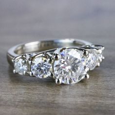 three stone diamond ring on wooden surface