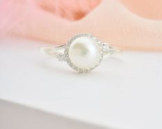 * Stunning handmade solid gold pearl ring. Adorned with tiny beads of white zircon gemstone to emphasize the unique design. This ring is designed to look elegant from all sides of your finger. You will not be able to take your eyes off the fascinating color of opal stone and the magnificent glitter of solid gold. 14K and 18K options are avaliable. It is suitable for daily use * ★Item Details ♥Made to Order ♥Gold Kt: 14K & 18K ♥Available Gold Color: Gold, Rose Gold, White Gold ♥Pearl Stone Si Pearl Ring With Diamond Accents, Fine Jewelry Diamond Ring With Pearl Drop, White Pearl Birthstone Ring In Fine Jewelry, Fine Jewelry White Pearl Birthstone Ring, Diamond Pearl Ring With Pearl Drop, White Pearl Birthstone Ring Fine Jewelry, Oval Pearl Drop Ring For Wedding, White Pearl Ring With Cubic Zirconia Center Stone, Heirloom Pearl Ring With Diamond Accents As Gift