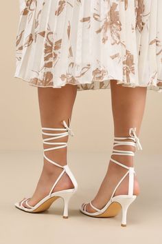 Make an entrance unlike any other with a fabulous look like the Lulus Lawrance White Lace-Up High Heel Sandals! Smooth faux leather shapes these trendy lil' heels that feature a classic square-toe footbed, a network of slender straps that create a peep-toe upper, and matching straps that weave through a supportive heel strap to wrap and tie above the ankle. 3. 25" wrapped stiletto heel. Cushioned insole. Rubber sole has nonskid markings. Man made materials. Imported. Lulus | Lawrance White Lace-Up High Heel Sandal Heels | Size 10. Fitted Square Toe Heels With Wrapped Heel, Fitted Sandals With Wrapped Block Heel, Modern Heels For Spring Wedding, Modern Spring Wedding Heels, Chic Block Heel Sandals For Events, Fitted Heels With Heel Strap For Event, Chic Summer Wedding Shoes For Gala, Fitted Low Heel Sandals For Events, Chic Square Toe Heels With Wrapped Heel