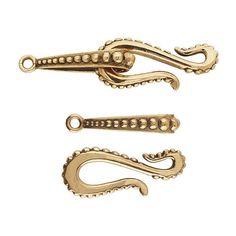 three gold colored metal hooks on a white background