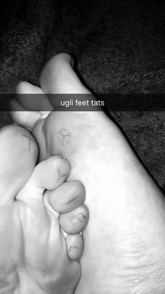 a black and white photo of a baby's foot with the word uglii feet written on it