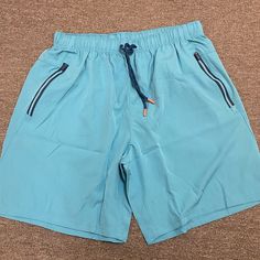 Blue Athletic Shorts Size Large. Brand New And Never Worn. Casual Blue Swim Trunks With Built-in Shorts, Blue Shorts With Pockets For Vacation, Light Blue Casual Bottoms For Poolside, Casual Blue Swim Trunks For Poolside, Blue Shorts With Pockets For The Beach, Blue Casual Swim Trunks For Poolside, Blue Beach Shorts With Pockets, Sporty Blue Shorts For Poolside, Blue Beach Bottoms With Pockets