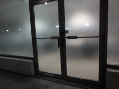 an empty room with frosted glass doors