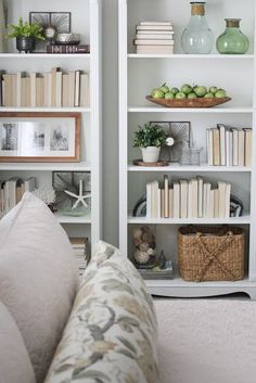 the bookshelves are filled with many different types of books and vases on them