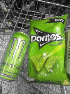 a bag of tortilla chips and a can of monster energy drink in a grocery cart