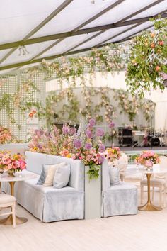 a living room filled with furniture and lots of flowers