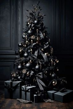 a black christmas tree with presents under it