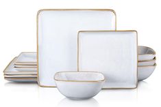 a set of white and gold dinnerware