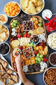 a wooden table topped with plates and bowls filled with different types of food on top of it