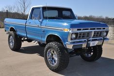 a blue pickup truck parked in a parking lot