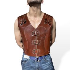 Men's Biker Vest - Genuine Cowhide Leather, Vintage Style, Brown This classic men's biker vest is crafted from premium genuine cowhide leather, designed for durability, comfort, and style. The vintage brown color gives it a timeless appeal, perfect for motorcycle riders or anyone looking to add rugged flair to their wardrobe. Features: -Material: 100% genuine cowhide leather, known for its strength and long-lasting wear. -Style: Vintage-inspired design with a sleek, tailored fit for a classic bi Brown Punk Leather Jacket For Biker Events, Sleeveless Biker Leather Jacket For Biker Events, Sleeveless Fitted Leather Biker Jacket, Fitted Sleeveless Leather Biker Jacket, Fitted Leather Vest With Rugged Style, Fitted Leather Vest In Rugged Style, Moto Vest For Biker Events, Punk Style Sleeveless Leather Vest, Leather Biker Vest For Biker Events