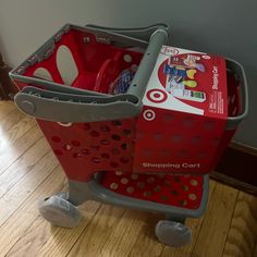 a red shopping cart with two baskets on the front and one basket in the back