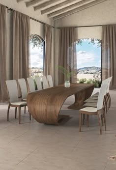 a large wooden table surrounded by white chairs in a room with windows and drapes