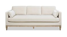 a white couch sitting on top of a wooden frame