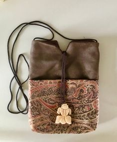 "This is a slightly larger bag than my very popular \"Precious.\" It's 7\" wide x 9\" long and it has both an outer pocket and an inner one. When you want to travel light, but need to carry more than just your phone, cash & cards, choose \"Sukara.\"" Gift Brown Pouch With Cell Phone Pocket, Brown Pouch With Cell Phone Pocket As Gift, Small Shoulder Bag With Removable Pouch For Daily Use, Brown Embroidered Everyday Bags, Brown Everyday Embroidered Bags, Gift Crossbody Bag With Pockets, Brown Bags With Zipper Pouch, Rectangular Shoulder Bag With Pockets For Gift, Crossbody Bag With Pockets As Gift