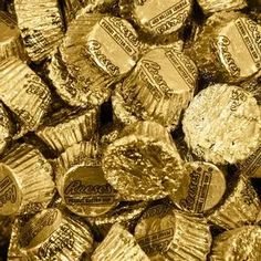 gold foiled chocolates are stacked on top of each other in this close up photo