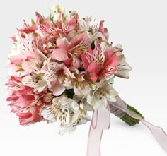 a bridal bouquet with pink and white flowers on it's side, tied in a ribbon