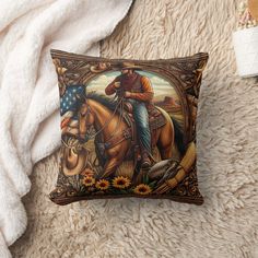 a pillow with a painting of a cowboy riding a horse and sunflowers on it