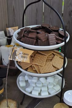 a three tiered tray filled with chocolate and marshmallows