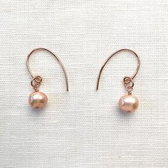 Cultured Freshwater Pearl & 14KT Rose-Gold Filled Earrings; Versatile to wear with a simple chain or a freshwater pearl necklace; Handcrafted in California Freshwater pearls are a light mauve, semi-round shape Earrings are 1" long with fishhook ear wires Each piece is hand-made No exchanges due to sanitary reasons Wear with the Freshwater Pearl & 14KT Rose Gold Necklace Cost-Saving Sparkle Set Bundle: These earrings are also part of the Pearl & Rose Gold Earring and Choker Set. ~ Necklace not in Dainty Rose Gold Round Pearl Earrings, Dainty Rose Gold Pearl Earrings, Dainty Rose Gold Pearl Earrings For Gift, Rose Gold Pearl Earrings For Gift, Dainty Rose Gold Pearl Earrings As Gift, Minimalist Hypoallergenic Rose Gold Pearl Earrings, Hypoallergenic Minimalist Rose Gold Pearl Earrings, Rose Gold Pearl Earrings With Pearl Charm For Gift, Delicate Hypoallergenic Rose Gold Pearl Earrings