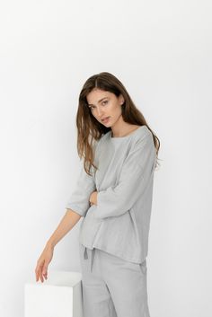 "When ordering you can choose to have the \"PANTS\" or \"TOP\" only or the whole \"PAJAMA SET\" of both items. When buying a set you save 5 euro. Comfortable relaxed fit EVA pajama pants in ice grey with pockets and fabric strap. Oversized CHLOE top in ice grey TOP: - length is ± 64 cm (25\") (depends on size) - wide mid-length sleeves - boxy fit BOTTOM: - outseam is ± 98 cm (38.5\") (depends on size) - inseam is ± 70 cm (27.5\") - elastic waistband with fabric strap - two side pockets DETAILS: Summer Sleepwear With 3/4 Sleeves, Casual Spring Sleepwear With 3/4 Sleeve, Casual 3/4 Sleeve Spring Sleepwear, Relaxed Fit Tops For Spring Pajama Party, Summer Loungewear Tops Half Sleeve, Summer Half-sleeve Loungewear Tops, Summer Half-sleeve Tops For Loungewear, Half Sleeve Tops For Summer Loungewear, Summer Half Sleeve Tops For Loungewear