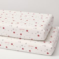 two sheets with ladybugs on them sitting next to each other in front of a white background