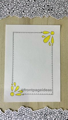 a piece of paper with yellow and white flowers on it next to a doily