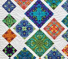 a colorful quilt with many different designs on it's sides and the center piece