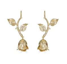 pair of gold earrings with leaves and flowers on the ear ends, set against a white background