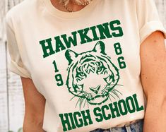 Hawkins High School Shirt, Vintage Hawking Town Shirt, Hawking Eleven Shirt, Hawkins Class Of 1986 T-shirt. School Tshirt Designs, Spirit Wear Designs, Hawkins High School, Class Tshirts, School Spirit Shirts Designs, Team Shirt Designs, Team Spirit Shirts, School Shirt Designs, Dance Tee