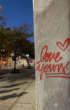 graffiti on the side of a building that says love yours