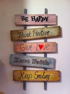 a wooden sign that says, be happy think positive give love have faith keep smiling