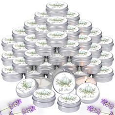 a bunch of candles that are next to some flowers and lavenders on a white background