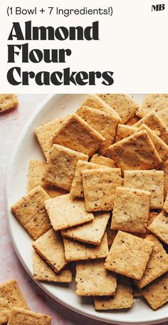 a white plate topped with crackers on top of a table