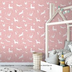 a bedroom with pink wallpaper and white deer silhouettes