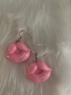 Description Embrace your love for unique accessories with these Pink Lips Wire Earrings from Alien Bratz! These quirky earrings feature hypoallergenic posts and are made with lightweight resin. Perfect for adding a playful touch to any outfit, they make a great Valentine's Day gift. (Only available while supplies last!) Details Resin Pink puckering Lips lightweight waterproof and very durable hypoallergenic posts Features One of a kind, fashion jewelry, everyday jewelry Great gift for that speci Trendy Pierced Resin Jewelry, Trendy Resin Drop Earrings, Trendy Silver Resin Earrings, Playful Pink Hoop Earrings Gift, Trendy Dangle Plug Earrings For Gift, Trendy Plug Earrings As Gift, Trendy Dangle Plug Earrings As Gift, Novelty Hypoallergenic Earrings For Party, Hypoallergenic Novelty Earrings For Party