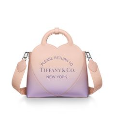 Inspired by one of the House’s most distinctive designs, the heart-shaped Return to Tiffany® handbags are crafted in supple leather with accents that nod to our iconic jewelry. This playful micro charm tote features our signature heart motif in palladium plating. Infinity morganite Taurillon leather; 13.8" W x 11.4" H x 4.3" D; Palladium-plated hardware, charms and chain link; Detachable woven strap and fixed handles; Interior pocket with zipper; Flap closure with magnet; Cotton-blend leather li Tiffany Bag, Iconic Jewelry, Return To Tiffany, Gifts To Buy, Heart Motif, Small Tote Bag, Pocket With Zipper, Small Tote, Morganite