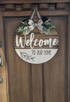 a welcome sign is hanging on the front door