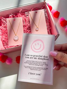 This set of necklaces makes for a perfect gift for your daughter- it's sure to bring a smile to your face and your daughter's too!. It includes two "Happy face" necklaces and comes with a lovely note, as shown in the picture. The necklaces are already packaged in a beautiful pink 5x7 inch box, ready to be gifted. At checkout, you can select the "this is a gift" option if you prefer not to display the invoice. PRODUCT DETAIL Necklace length: 15.5"with 16.5" and 17.5"Extender Gold dipped Hypoaller Inspirational Pink Jewelry For Gift, Inspirational Pink Jewelry For Gifts, Mother's Day Gift Wrapped Necklace, Personalized Pink Charm Necklace As Gift, Birthday Gift Necklaces With Message Card, Pink Inspirational Jewelry For Valentine's Day, Pink Jewelry For Birthday Gift On Mother's Day, Pink Hypoallergenic Necklace For Mother's Day, Pink Jewelry For Birthday And Mother's Day