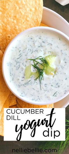 a white bowl filled with soup next to some tortilla chips and a green garnish