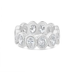 a white gold ring with round diamonds on the sides and four stones in the middle