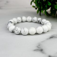 Imagine a piece of jewelry that not only adds a touch of elegance but also tells a story of mystical adventures and bohemian wanderlust. Our Enchanted White Howlite Boho Bead Bracelet is just that! Inspired by the calming aura of White Howlite and the free-spirited essence of bohemian fashion, this bracelet is crafted to perfection. Origin Story: The idea for this bracelet came from a serene walk through a mystical forest, where the shimmering white stones seemed to whisper tales of ancient wisd Elegant White Crystal Friendship Bracelet, Elegant White Crystal Bracelet For Friendship, White Crystal Bracelet With 8mm Beads, Howlite Bracelets With Round Beads As Gift, White Minimalist Crystal Bracelet With Round Beads, White Gemstone Beads Bracelet As Gift, Adjustable White Bracelets For Jewelry Making, Adjustable Howlite Bracelet With 8mm Beads, White Bracelets With 8mm Adjustable Beads