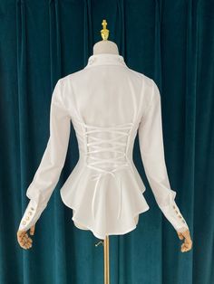 An embroidered blouse that looks like an aristocratic lady from medieval Europe. A cross and a rose are embroidered on the collar with gold thread (white) and silver thread (gray), and ivy is also embroidered on the cuffs. The back is decorated with lacework, and the chest is decorated with frills, pleats, and lace embroidery. For a young lady with a gorgeous atmosphere. 
 
 

 

 
 
 
 Color 
 
 White 
 Gray 
 
 
 Size 
 
 
 S size 
 
 Length: 60cm 
 Shoulder width: 37cm 
 Bust: 86cm 
 Waist: 7 Elegant Cotton Blouse For Fall, Spring Season Gothic Formal Tops, Victorian Cotton Fitted Blouse, Fitted Victorian Cotton Blouse, Spring Formal Gothic Blouse, Spring Gothic Formal Blouse, Elegant Cotton Tops For Wedding, Medieval Style Fitted Long Sleeve Top, White Fitted Victorian Blouse