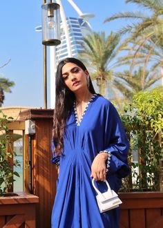 Azure blue georgette silk kaftan with details on the neckline, sleeves and back. Elegant Silk Tunic For Eid, Blue Silk Kurta For Summer, Blue Dresses With Cape Sleeves For Eid, Traditional Blue Kurta With Embroidered Neckline, Blue Traditional Kurta With Embroidered Neckline, Elegant Embroidered Neckline Tunic For Summer, Elegant Summer Tunic With Embroidered Neckline, Summer Blue Georgette Kurta, Blue Georgette Kurta For Summer