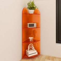 an orange shelving unit with a microwave and plant in it next to a window